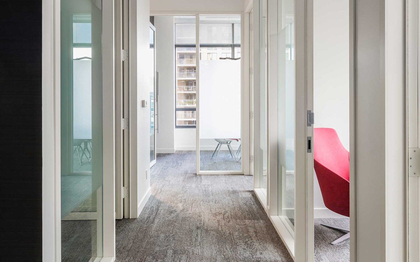 a long hallway with doors to bright modern law offices branching off from either side